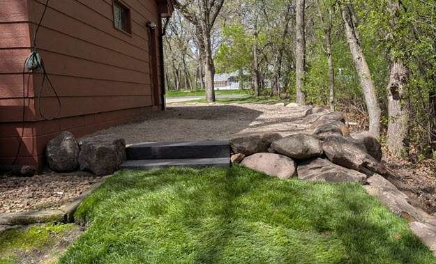boulder-retaining-wall-landscaping-ramsey-mn-after-back boulder retaining wall project from the backyard