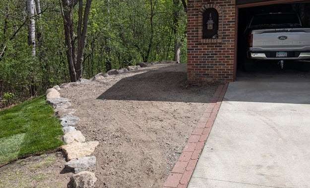 boulder-retaining-wall-landscaping-ramsey-mn-after-front finished boulder retaining wall project from the front